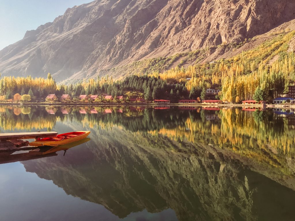lower-kachura-lake-autumn-docked-boat-reflection-mountain-still-water