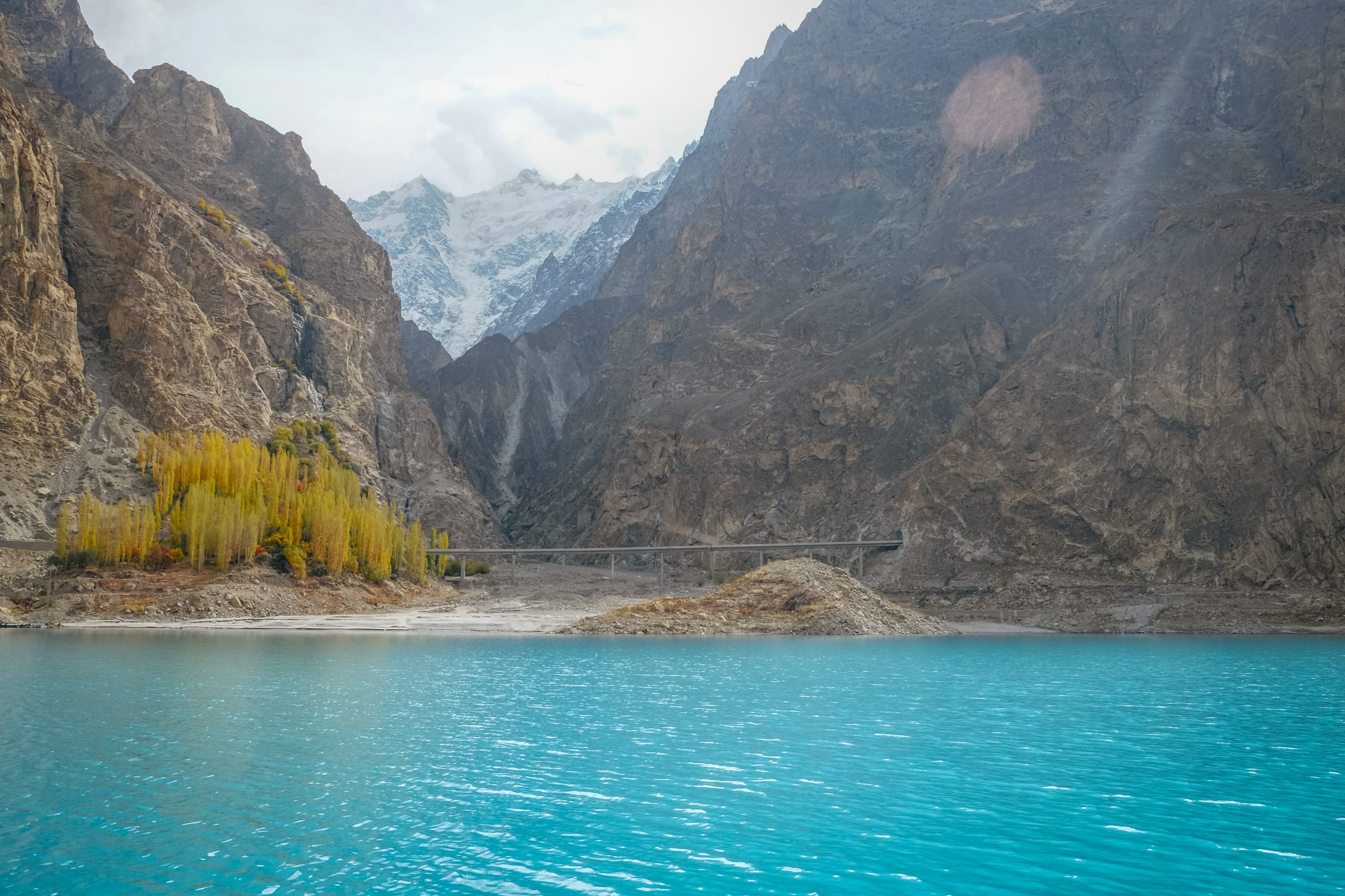 turquoise-water-attabad-lake-autumn-season-against-snow-capped-mountain-range-1